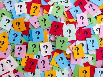 Question marks written on coloured paper